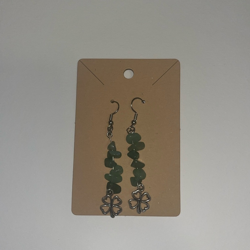 Handmade gemstone earning with a four leaf clover at the bottom.